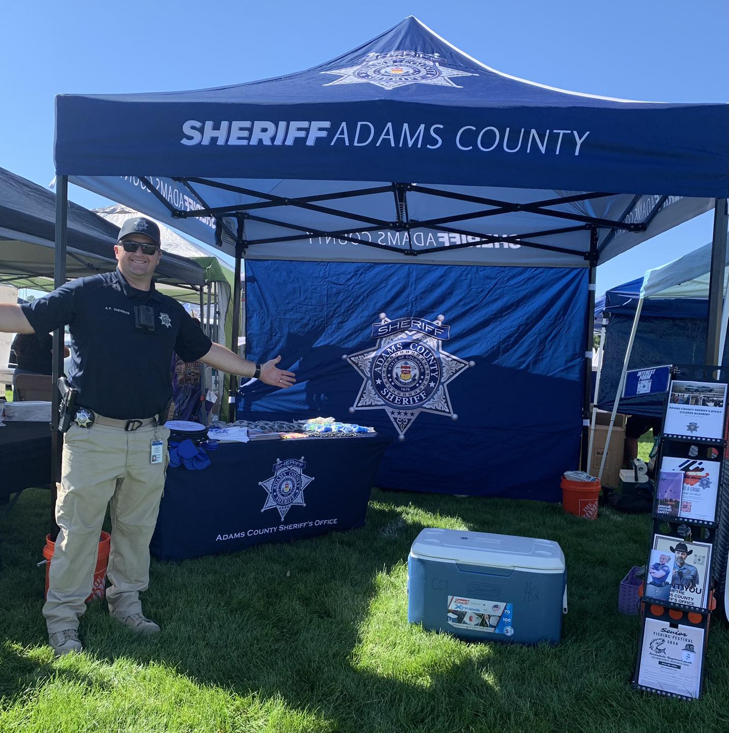 Photo of the Adams County Sheriff's Office's Public Information Officer at a recruiting booth.